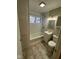 Bathroom with tub, window, vanity, neutral paint, linoleum flooring, and built in storage at 4224 N Arlington Ave, Indianapolis, IN 46226