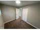 Cozy bedroom with neutral paint, carpet floors, closet, and adjacent access to another room at 4224 N Arlington Ave, Indianapolis, IN 46226