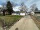 A one-story home shows off its large driveway and well-kept lawn in a quiet neighborhood at 4224 N Arlington Ave, Indianapolis, IN 46226