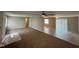 Spacious living room featuring neutral paint, plush carpeting, and abundant natural light from sliding glass door at 4224 N Arlington Ave, Indianapolis, IN 46226