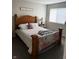 Comfortable bedroom with natural light and a wooden bed frame at 4480 Village Ln # 2, Indianapolis, IN 46254