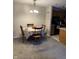 Cozy dining area with a round table, wooden chairs, and soft gray carpet at 4480 Village Ln # 2, Indianapolis, IN 46254