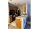 Efficient kitchen featuring modern appliances, light countertops, and wood cabinetry at 4480 Village Ln # 2, Indianapolis, IN 46254