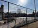 Fenced community pool with a glimpse of surrounding residential buildings at 4480 Village Ln # 2, Indianapolis, IN 46254