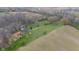 Overhead view of a home with a large yard, surrounded by green fields and trees at 4935 W Carriage Dr, New Palestine, IN 46163