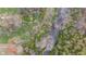 Aerial view of a river flowing through a lush forest and trees, surrounded by greenery and natural beauty at 4935 W Carriage Dr, New Palestine, IN 46163