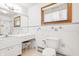 Bright bathroom featuring white tiles and fixtures, complemented by natural light at 4935 W Carriage Dr, New Palestine, IN 46163