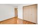 Bedroom with hardwood floors and a closet with sliding doors at 4935 W Carriage Dr, New Palestine, IN 46163