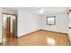 The bright bedroom features hardwood floors, a ceiling fan, natural light, and access to additional rooms at 4935 W Carriage Dr, New Palestine, IN 46163