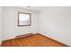 Bedroom with hardwood floors, white walls, and a window at 4935 W Carriage Dr, New Palestine, IN 46163