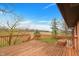 Expansive wooden deck overlooking the open backyard and scenic landscape at 4935 W Carriage Dr, New Palestine, IN 46163