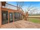 Multi-tiered wooden deck, offering outdoor space and serene views of the backyard at 4935 W Carriage Dr, New Palestine, IN 46163
