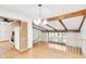 Open dining area with hardwood floors, exposed beams, and staircase at 4935 W Carriage Dr, New Palestine, IN 46163