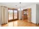 Dining area with hardwood floors, sliding glass doors to a deck, and natural light at 4935 W Carriage Dr, New Palestine, IN 46163