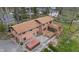 Aerial view of a two-story brick house with a large wooden deck and a spacious backyard surrounded by mature trees at 4935 W Carriage Dr, New Palestine, IN 46163