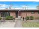 Brick home featuring a brick walkway, small garden, and red front door at 4935 W Carriage Dr, New Palestine, IN 46163