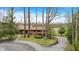 Traditional brick home boasts a circular driveway and beautifully landscaped front yard with mature trees at 4935 W Carriage Dr, New Palestine, IN 46163