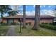 Charming brick home featuring a brick walkway, mature trees, and lush green landscaping at 4935 W Carriage Dr, New Palestine, IN 46163