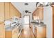 Bright kitchen with natural wood cabinetry, modern appliances, and a tile countertop at 4935 W Carriage Dr, New Palestine, IN 46163