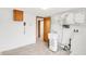 Functional laundry area with a sink, cabinetry, and well-organized storage for supplies at 4935 W Carriage Dr, New Palestine, IN 46163
