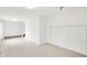 This living room provides a bright and airy space, featuring neutral walls and carpet at 4935 W Carriage Dr, New Palestine, IN 46163