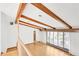 Spacious living room with vaulted ceilings, hardwood floors, large windows, and natural light at 4935 W Carriage Dr, New Palestine, IN 46163