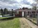 Fenced backyard featuring a trampoline, brick exterior, and a patio, perfect for outdoor activities at 5368 Southeastern Ave, Indianapolis, IN 46203