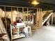 View of the unfinished basement with visible framing, concrete floors and overhead utilities at 5368 Southeastern Ave, Indianapolis, IN 46203