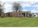 Charming single-story brick home with a well-manicured front lawn and inviting front porch at 5368 Southeastern Ave, Indianapolis, IN 46203