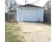 Detached one car garage with driveway and white siding, providing parking or storage at 5368 Southeastern Ave, Indianapolis, IN 46203