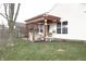 A delightful backyard patio with a pergola-covered seating area, perfect for outdoor entertaining at 5437 Powder River Ct, Indianapolis, IN 46221