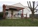 A delightful backyard patio with a pergola-covered seating area, perfect for outdoor entertaining at 5437 Powder River Ct, Indianapolis, IN 46221