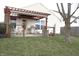 A delightful backyard patio with a pergola-covered seating area, perfect for outdoor entertaining at 5437 Powder River Ct, Indianapolis, IN 46221