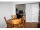 Cozy dining area with hardwood floors and a wooden table for four, located next to the living room at 5437 Powder River Ct, Indianapolis, IN 46221