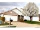 Exterior view of house featuring garage, brick accents, and flowering tree in the front yard at 5437 Powder River Ct, Indianapolis, IN 46221