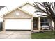 Charming single-Gathering home with brick facade, attached two-car garage, and well-maintained front lawn at 5437 Powder River Ct, Indianapolis, IN 46221