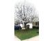View of front yard with flowering tree and parked cars in front of the house at 5437 Powder River Ct, Indianapolis, IN 46221
