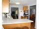 Bright kitchen with white countertops and wood cabinets; fridge and dining visible in the adjacent room at 5437 Powder River Ct, Indianapolis, IN 46221