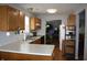 Functional kitchen with white countertops and wood cabinets, open to the living area and dining area at 5437 Powder River Ct, Indianapolis, IN 46221