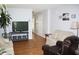 Cozy living room featuring hardwood floors, a television, couches, and decor at 5437 Powder River Ct, Indianapolis, IN 46221