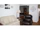 Living room with hardwood floors, couches, armchair, lamp, and artwork at 5437 Powder River Ct, Indianapolis, IN 46221