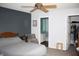 Relaxing main bedroom with a ceiling fan and a view into the adjacent bathroom and closet at 5437 Powder River Ct, Indianapolis, IN 46221