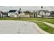 A community playground featuring swings and play structures sits near a sidewalk in a residential area at 5437 Powder River Ct, Indianapolis, IN 46221