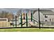A playground with a slide and climbing structures is set against a backdrop of neighborhood homes at 5437 Powder River Ct, Indianapolis, IN 46221