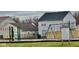 Community playground with swings and jungle gym surrounded by green space near neighborhood homes at 5437 Powder River Ct, Indianapolis, IN 46221