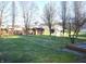Spacious backyard with mature trees and a small storage shed, perfect for outdoor activities and relaxation at 5819 Bar Del E Dr, Indianapolis, IN 46221