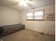 Neutral colored bedroom with carpet, a small bed, window, and a wall air conditioning unit at 5819 Bar Del E Dr, Indianapolis, IN 46221