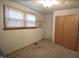 Neutral carpeted bedroom with a window, closet, and a wall air conditioning unit at 5819 Bar Del E Dr, Indianapolis, IN 46221