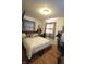 Carpeted bedroom featuring a cozy bed, desk, and window for natural light at 5819 Bar Del E Dr, Indianapolis, IN 46221