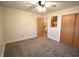 Clean, carpeted bedroom with double closets, overhead lighting, and an adjacent bathroom entrance at 5819 Bar Del E Dr, Indianapolis, IN 46221